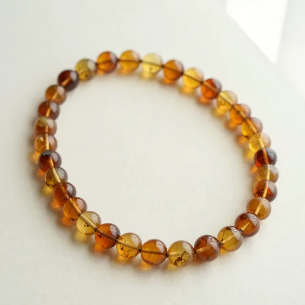 Illustrative: an early 20th-century graduated cognac Baltic amber bead necklace, natural and untreated