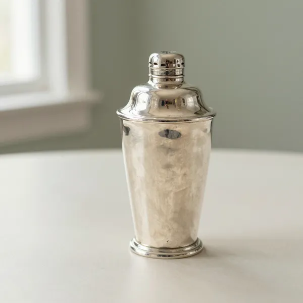 Illustrative: mid-century sterling silver cocktail shaker with a hallmarked base