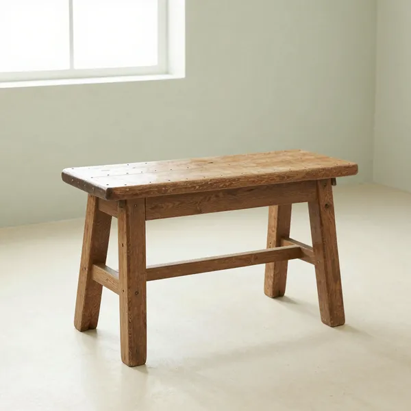 Illustrative: a 17th-century English oak joint stool with pegged mortise-and-tenon joinery and a worn original surface