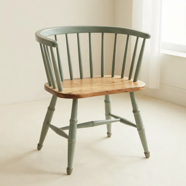 Illustrative: a 19th-century American Windsor stool in pine and maple with splayed legs and old paint