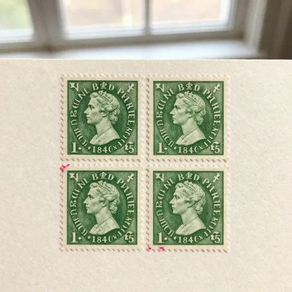 Illustrative: an 1840 Penny Black with four clear margins and a light red cancellation